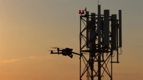 Drone flying near a cell tower for industrial inspection and maintenance during 스톡 동영상 345502768