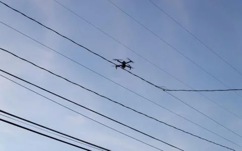 Drone flying near powerlines Stock Photos