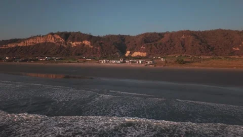 Drone Flying From Ocean Shore Toward Beach Under Clear Blue Sky Stock Footage 343419368