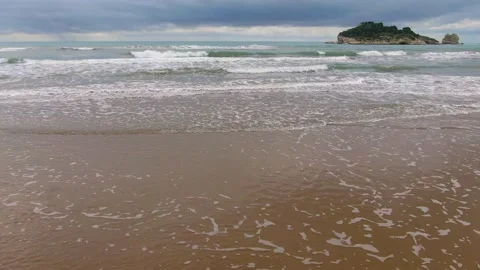 Drone Flying Out Into Gentle Waves on Beach in Italy Stock Footage 220804901