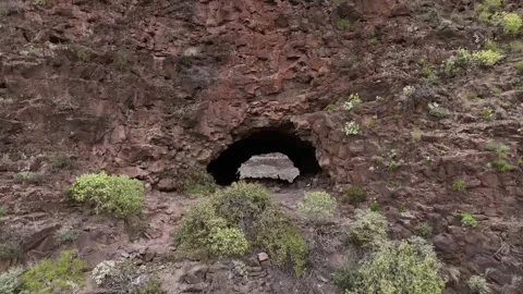 Drone Flying out from Volcanic Cave in Gran Canaria, Canary Islands Stock Footage 309880338