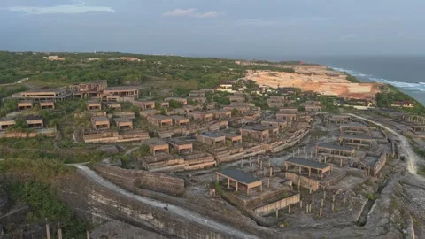 Drone flying over an abandoned construction site on bali's coastline Stock Footage 328921954