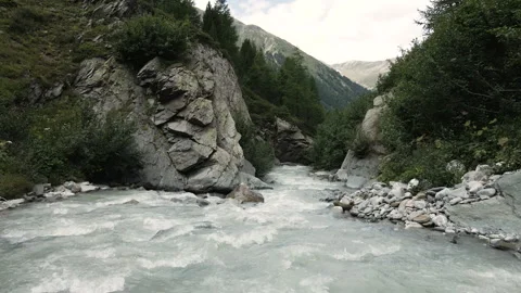 Drone flying over alpine glacial white river of Val Nera Livigno Stockbeeldmateriaal 256204308