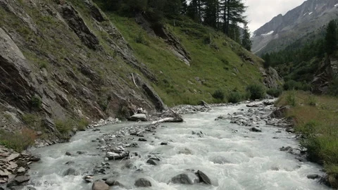 Drone flying over alpine glacial white river of Val Nera Livigno Stockbeeldmateriaal 256204903