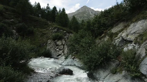 Drone flying over alpine glacial white river of Val Nera Livigno Stockbeeldmateriaal 256208376