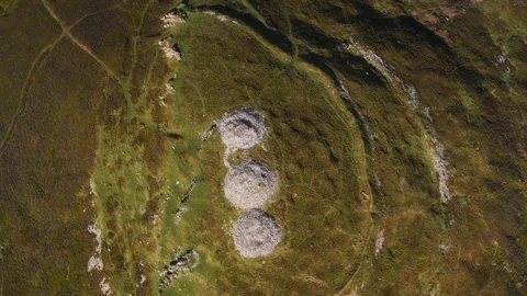 Drone flying over ancient bronze age burial mounds Stock Footage 336755563