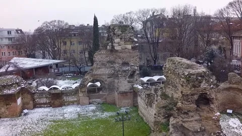 Drone flying over ancient roman ruins in winter with snow Stock-Footage 346409727