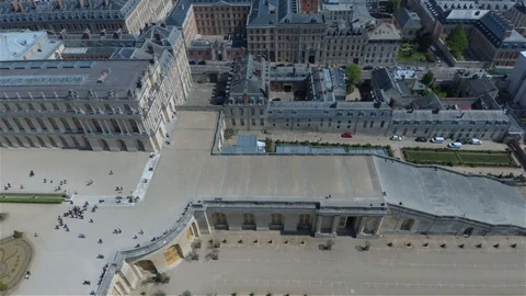 Drone flying over and out of Palais de Versailles showing street and cars Stock Footage 114715595
