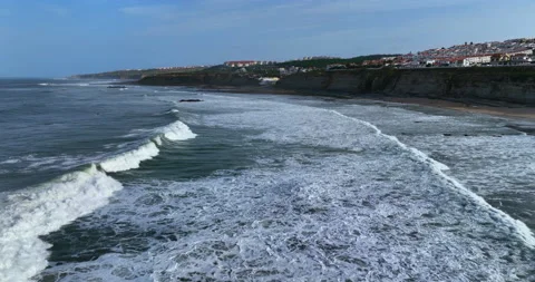 Drone flying over the Atlantic ocean foamy waves rolling at rocky shore. Aerial Stock Footage 222731774