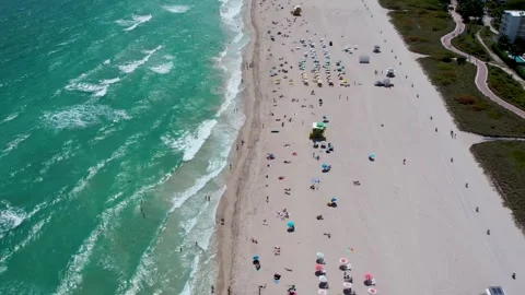 A drone flying over the beach in Miami with many people Stock Footage 248526221
