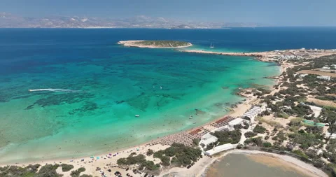 Drone flying over the beach in Paros with people swimming and relaxing. Stock-Footage 232488179
