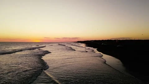 A drone flying over a beach at sunset. Stock Footage 151426858