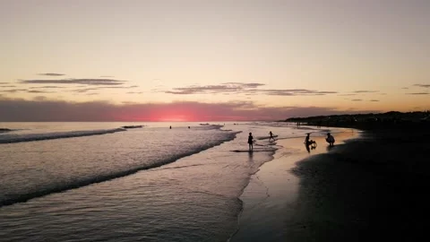 A drone flying over a beach at sunset. Stock Footage 151427087