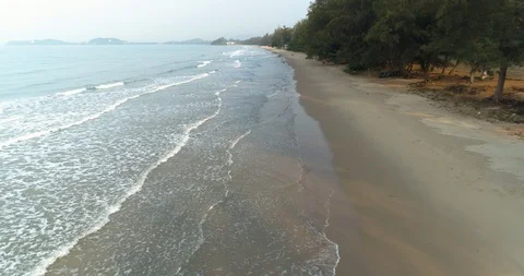 Drone flying over the beach watching the waves roll in at Mae Pim beach Stock Footage 108418114