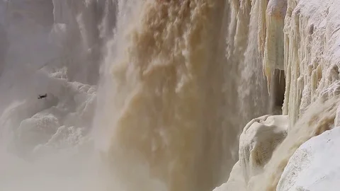 Drone flying over beautiful partially frozen Alexandra fall waterfall in NWT Stock Footage 78767610