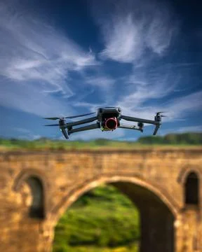 Drone flying over blurred background with old bridge Stock Photos