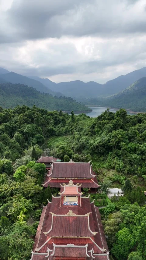 Drone Flying Over Buddhist Temple in Mountainous Forest Landscape in Hue, Stock Footage 335846327