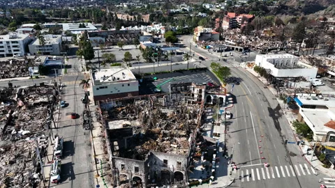 Drone flying over the burnt Pacific Palisades district, wildfire aftermath in LA Stock Footage 301296508