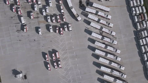 Drone flying over bus fleet shot from directly above Stock Footage