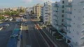 Drone flying over car parking and high buildings placed near beach, Larnaca city HD Footage