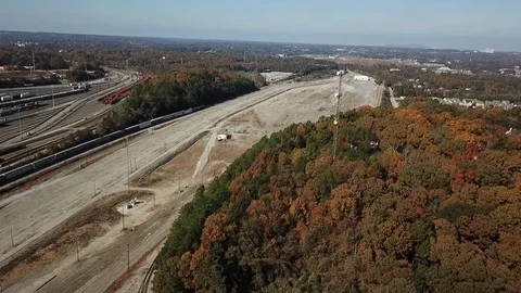 Drone flying over a cell tower with a moving train in the background Stockbeeldmateriaal 101214784
