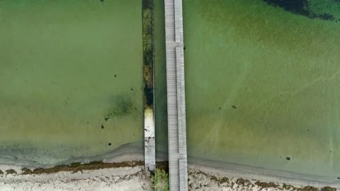 Drone flying over circular pier in the sea, drone stock footage by DroneRune Stock Footage 138696103