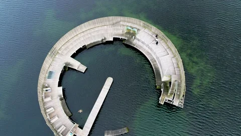 Drone flying over circular pier in the sea, drone stock footage by DroneRune Stock Footage 138696528