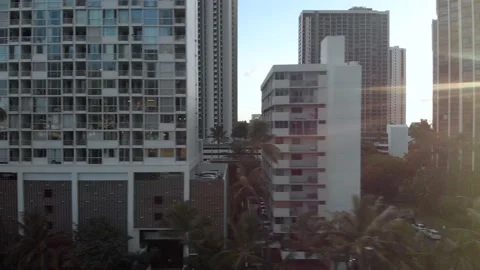 Drone Flying Over City Streets At Sunset In Waikiki, Honolulu, Hawaii Stock Footage 154164491