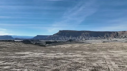 Drone flying over cliffside and into amazing desert valley Stock Footage 165566946