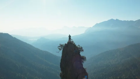 Drone flying over climber celebrating his victory Stock Footage 101900204