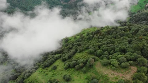 Drone Flying Over Cloud-Covered Green Mountains | Scenic Valley Landscape 4K Stock Footage 320827088