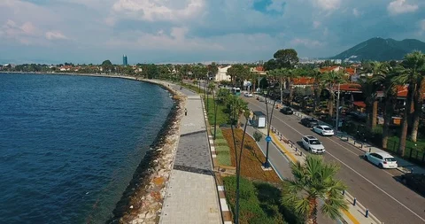 Drone flying over the coast line 4k. Aerial view of sea waves, street and city Stock Footage 91972289