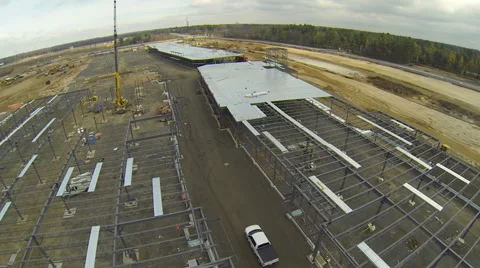 Drone flying over construction site while a truck passing through Stock Footage 63937932
