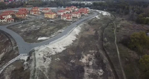 Drone flying over a construction site, around trees, a lake and sand Vídeos de archivo 130650796