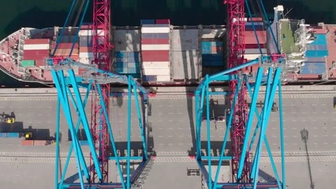 Drone flying over a container ship during cargo operations over the customs area Stock Footage 137220486
