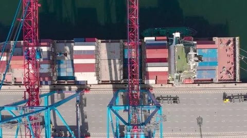 Drone flying over a container ship during cargo operations over the customs area Stock Footage 137220584