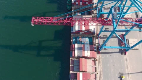 Drone flying over a container ship during cargo operations over the customs area Stock Footage 137220631