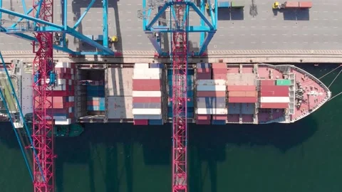 Drone flying over a container ship during cargo operations over the customs area Stock Footage 137220939