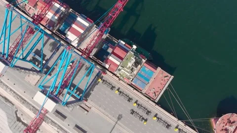 Drone flying over a container ship during cargo operations over the customs area Stock Footage 137220989