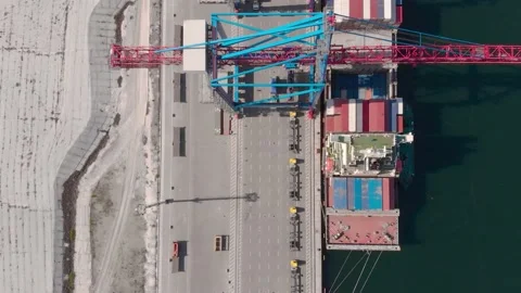 Drone flying over a container ship during cargo operations over the customs area Stock Footage 137221079