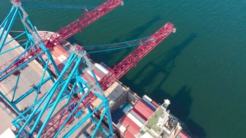 Drone flying over a container ship during cargo operations over the customs area Stock Footage 137221161