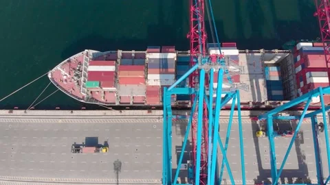 Drone flying over a container ship during cargo operations over the customs area Stock Footage 137221237