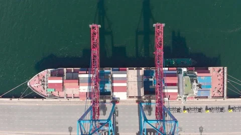 Drone flying over a container ship during cargo operations over the customs area Stock Footage 137221315