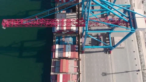 Drone flying over a container ship during cargo operations over the customs area Stock Footage 137221434
