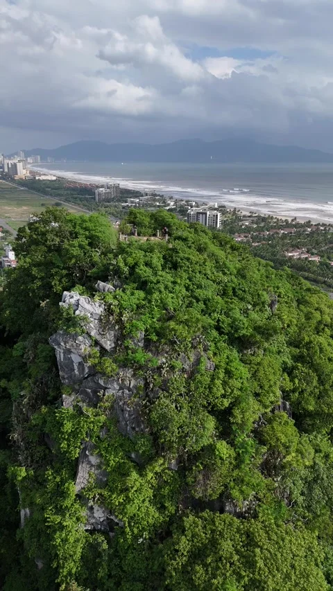 Drone Flying Over Da Nang's Marble Mountains Revealing the Coastline in Vietnam Stock Footage 335833903