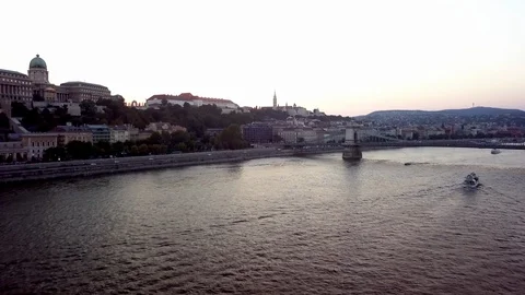 Drone flying over the Danube River towards the Budapest Chain Bridge 動画素材 114667489