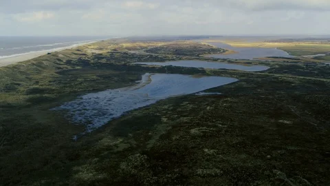Drone flying over desolate, rough marshland, drone stock footage by DroneRune Stock Footage 128076411