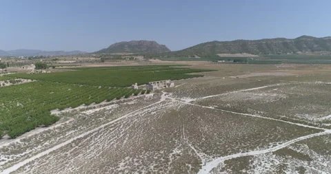 Drone flying over dry lagoon and crops on the edge of the salt flat Stock Footage 210441146