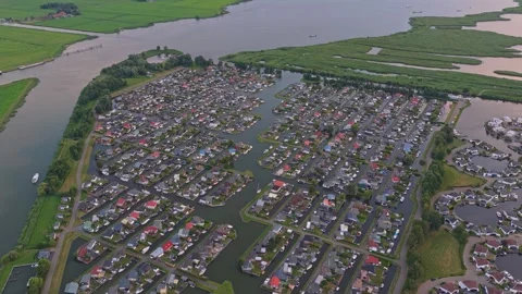 Drone flying over dutch marina and waterfront homes Stockbeeldmateriaal 341876214