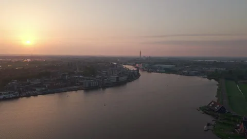 Drone flying over Dutch river toward the setting sun Stock Footage 309313120